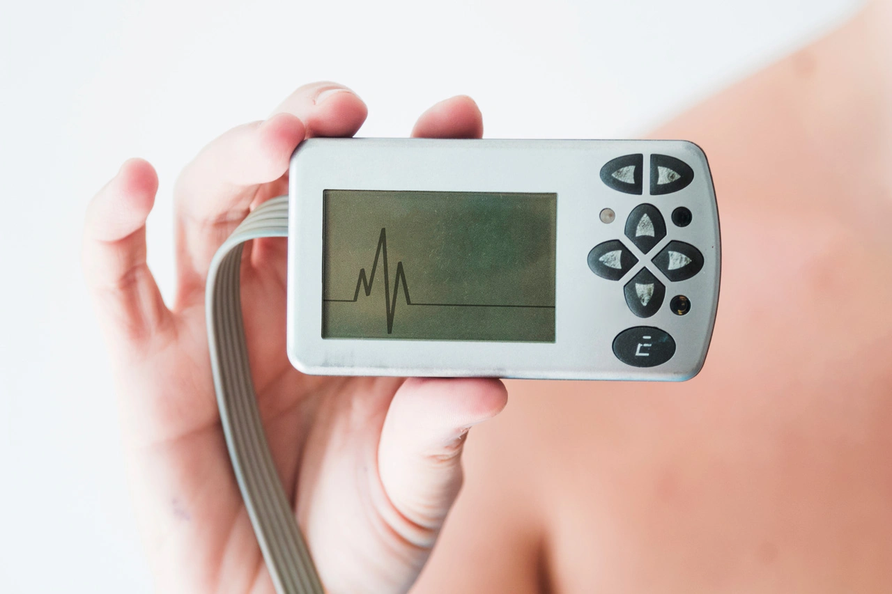 person-hand-holding-monitor-with-cardiogram person-hand-holding-monitor-with-cardiogram